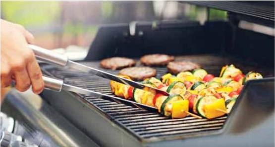 Vegetables and patties on a barbeque grill